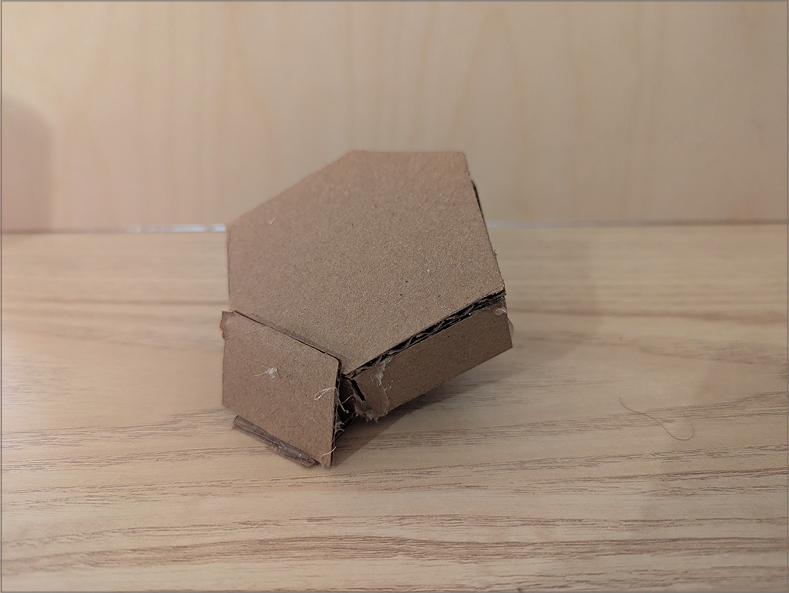 Photo of a lamp prototype. This prototype is more conceptual in its current stage. As I was considering utilising screens, I thought of how it could be encorperated. The screen would sit in front, and the hexagonal pannel on top would be the diffusor, with the sides and stand made of wood.